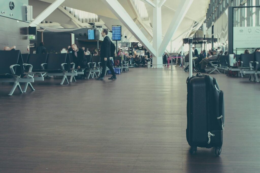 Black suitcase standing in an airport terminal