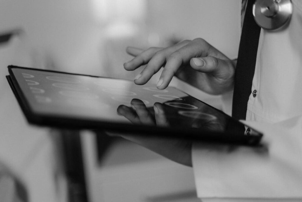 Hand using a touchscreen tablet in a clinic