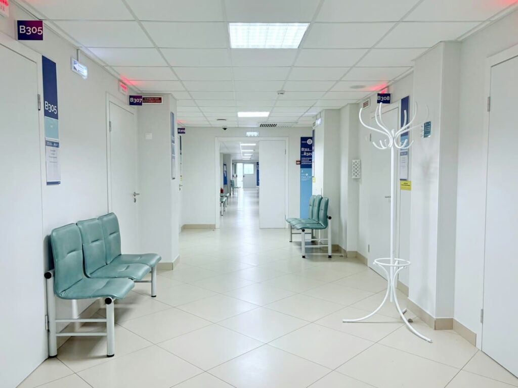 Quiet, empty clinic corridor with benches