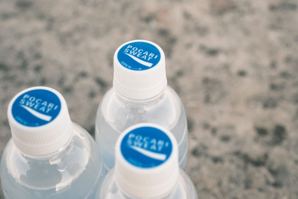 Bottles of electrolyte drink on a stone surface