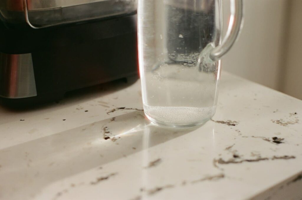 Glass jug of water on a kitchen counter