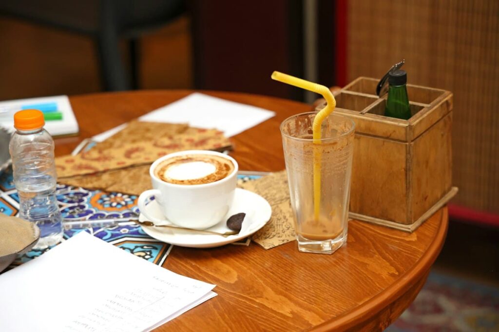Coffee and a cold drink on a wooden cafe table
