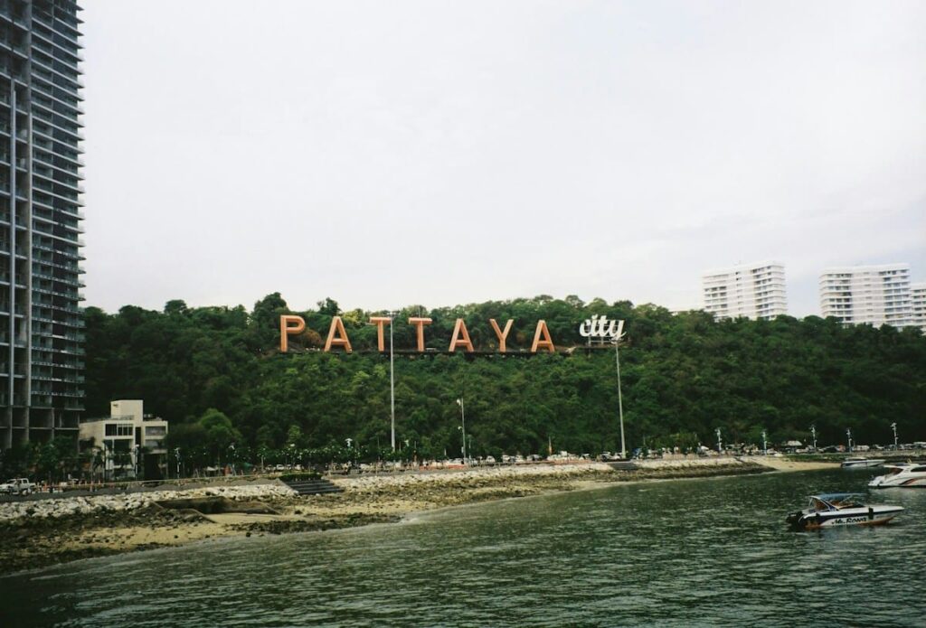 Pattaya City sign on the hillside above the bay