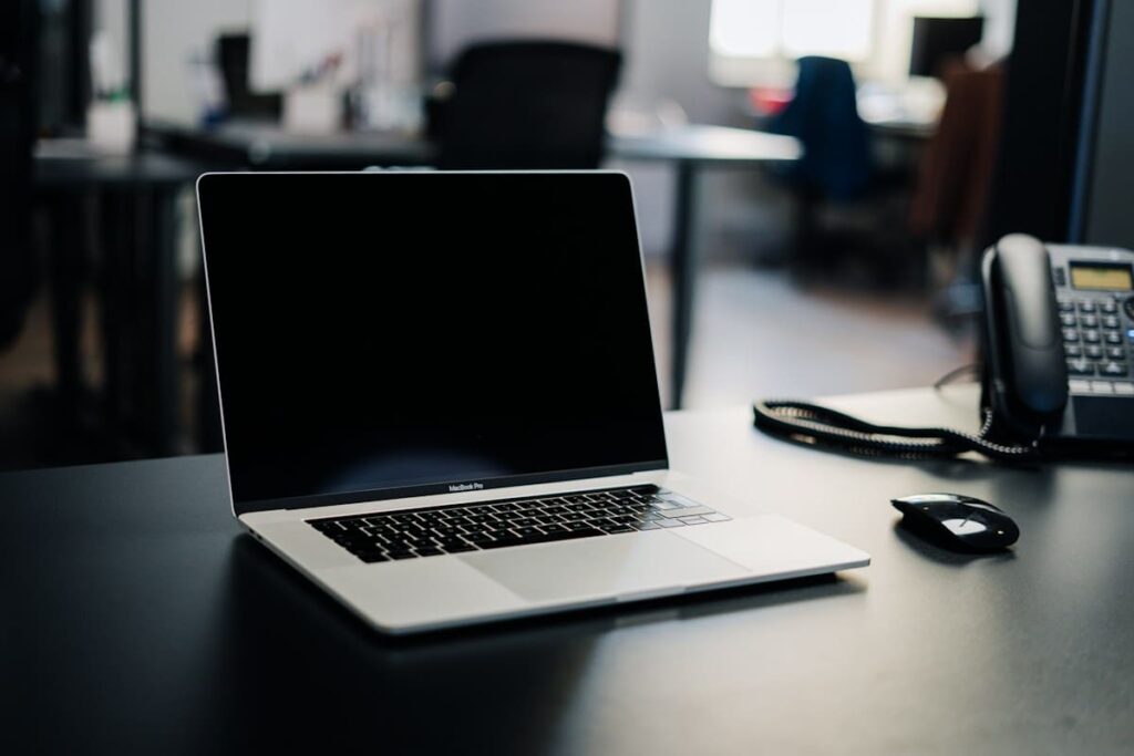 Laptop open on a white table