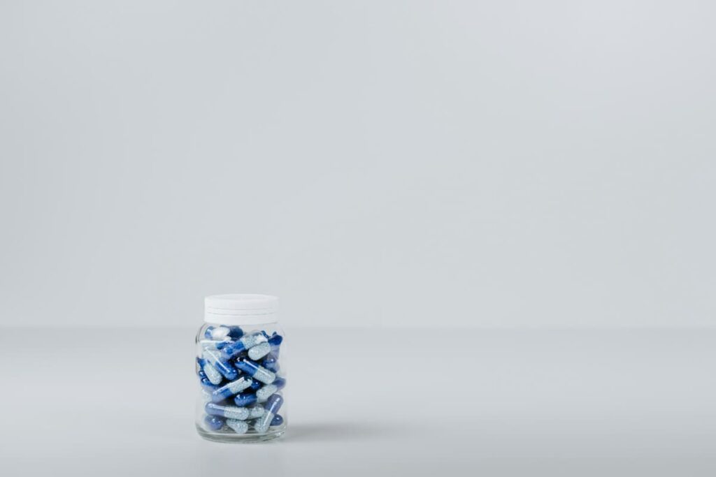Small bottle of blue and white capsules