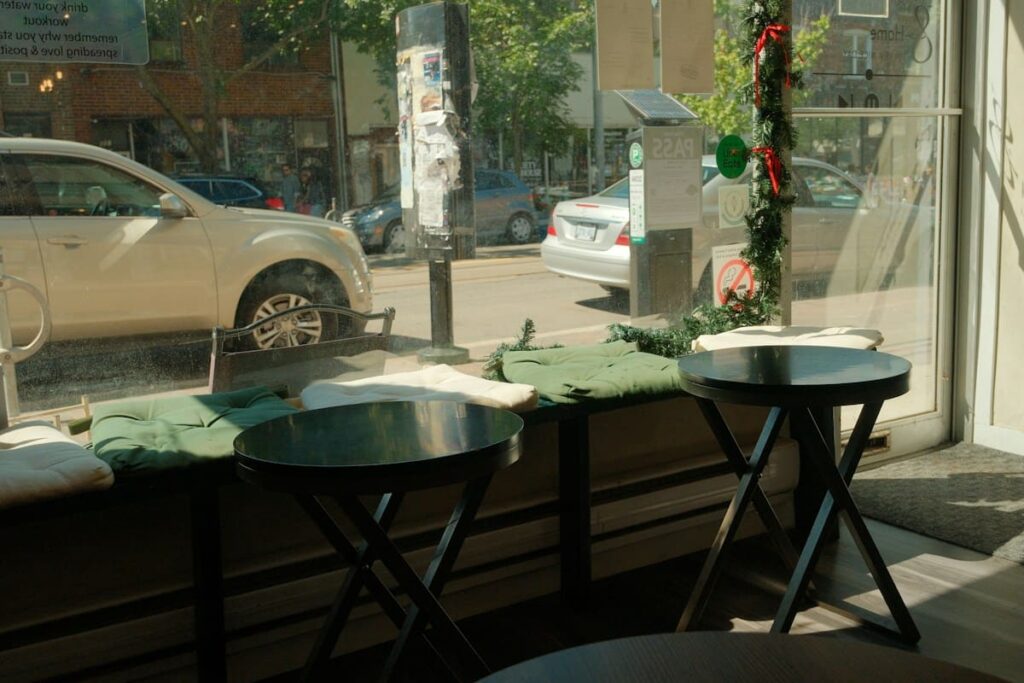Empty cafe tables by a sunny window