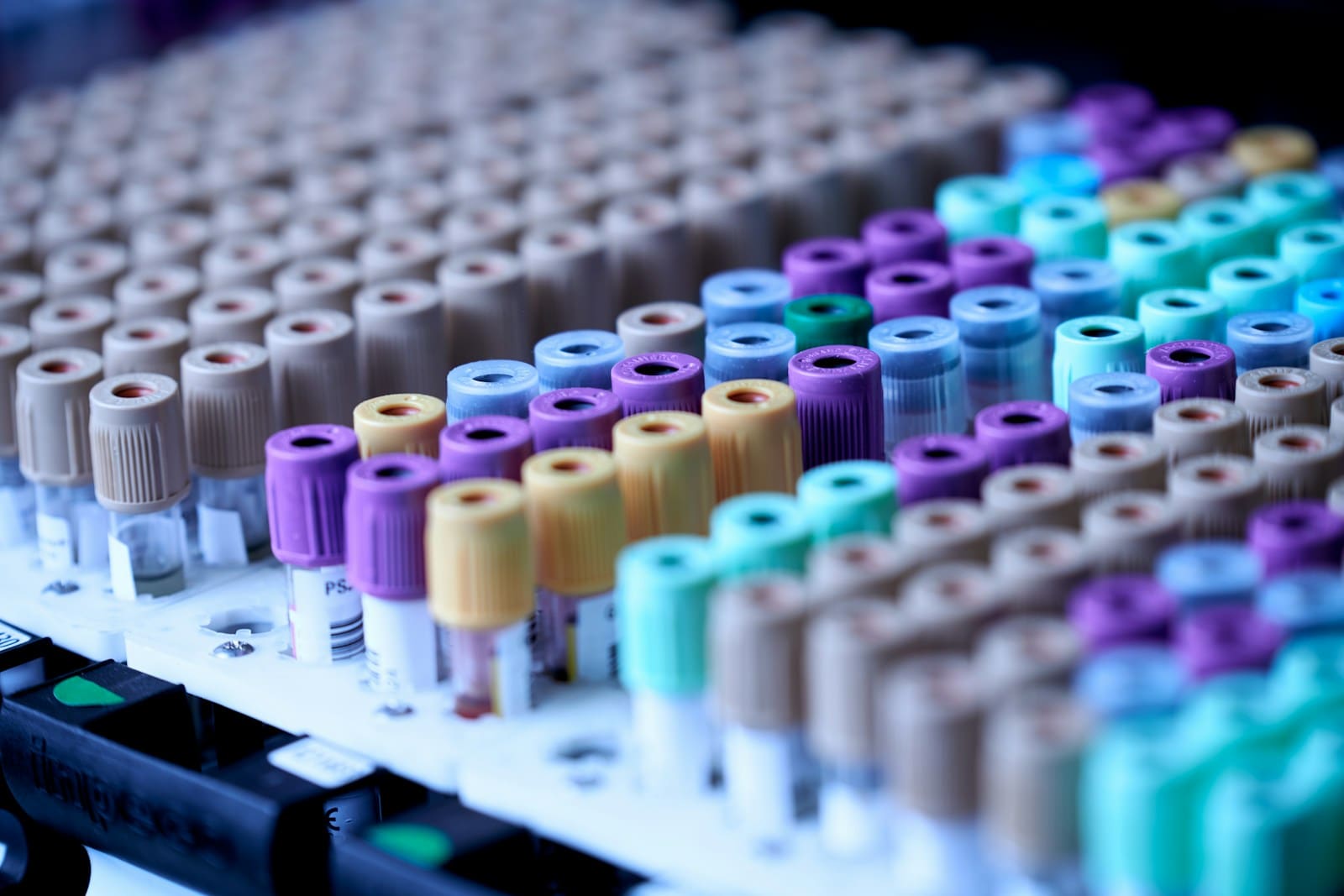 Rows of blood collection tubes with coloured caps