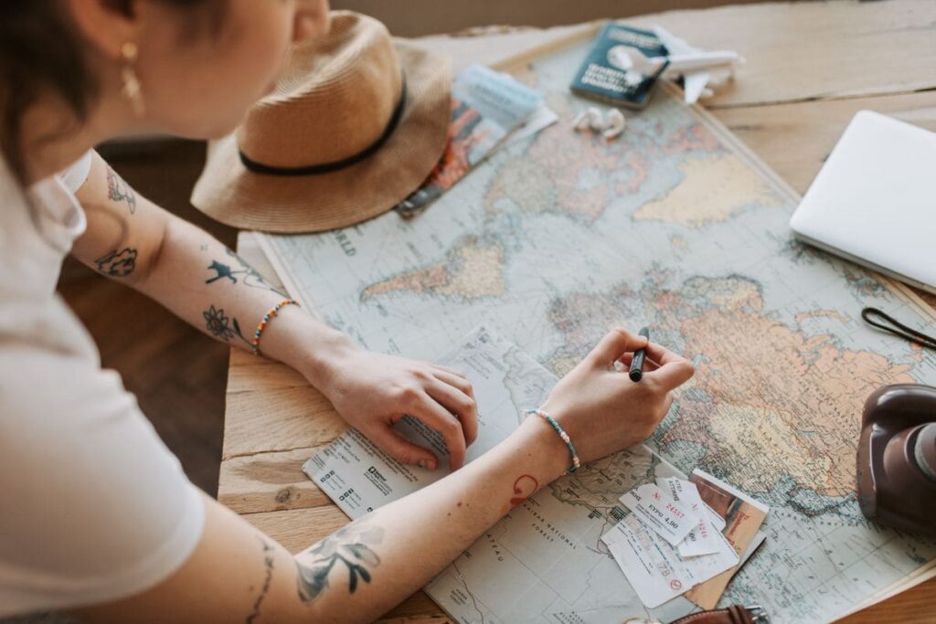 Map, passport and travel essentials laid out for trip planning