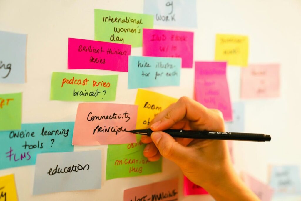 Hand writing on a board of sticky notes