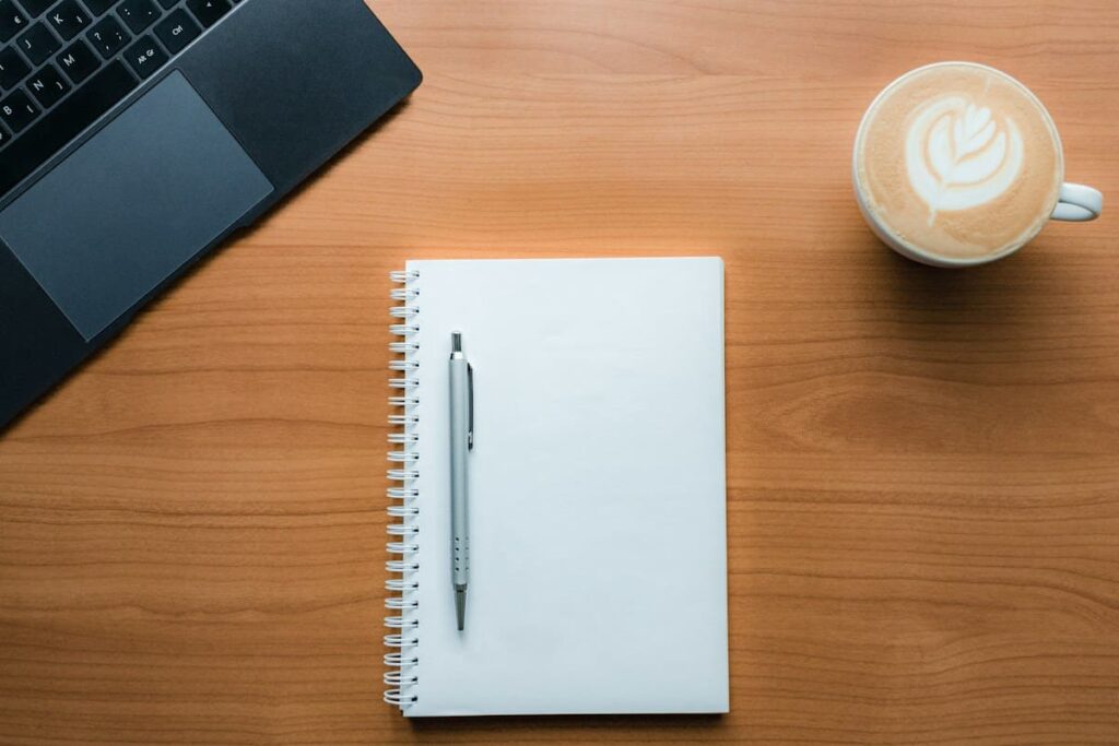 Pen and a cup of coffee on a table, ready for planning